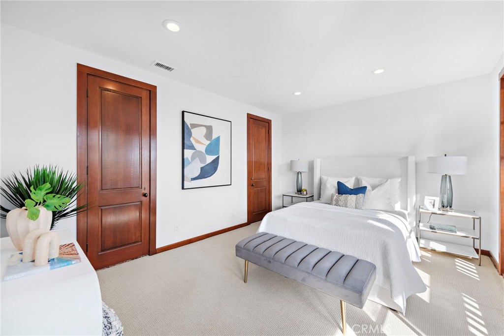 521 Kings Road Newport Beach, CA 92663 - Photo 32 of 48 a bedroom with a large bed and a potted plant
