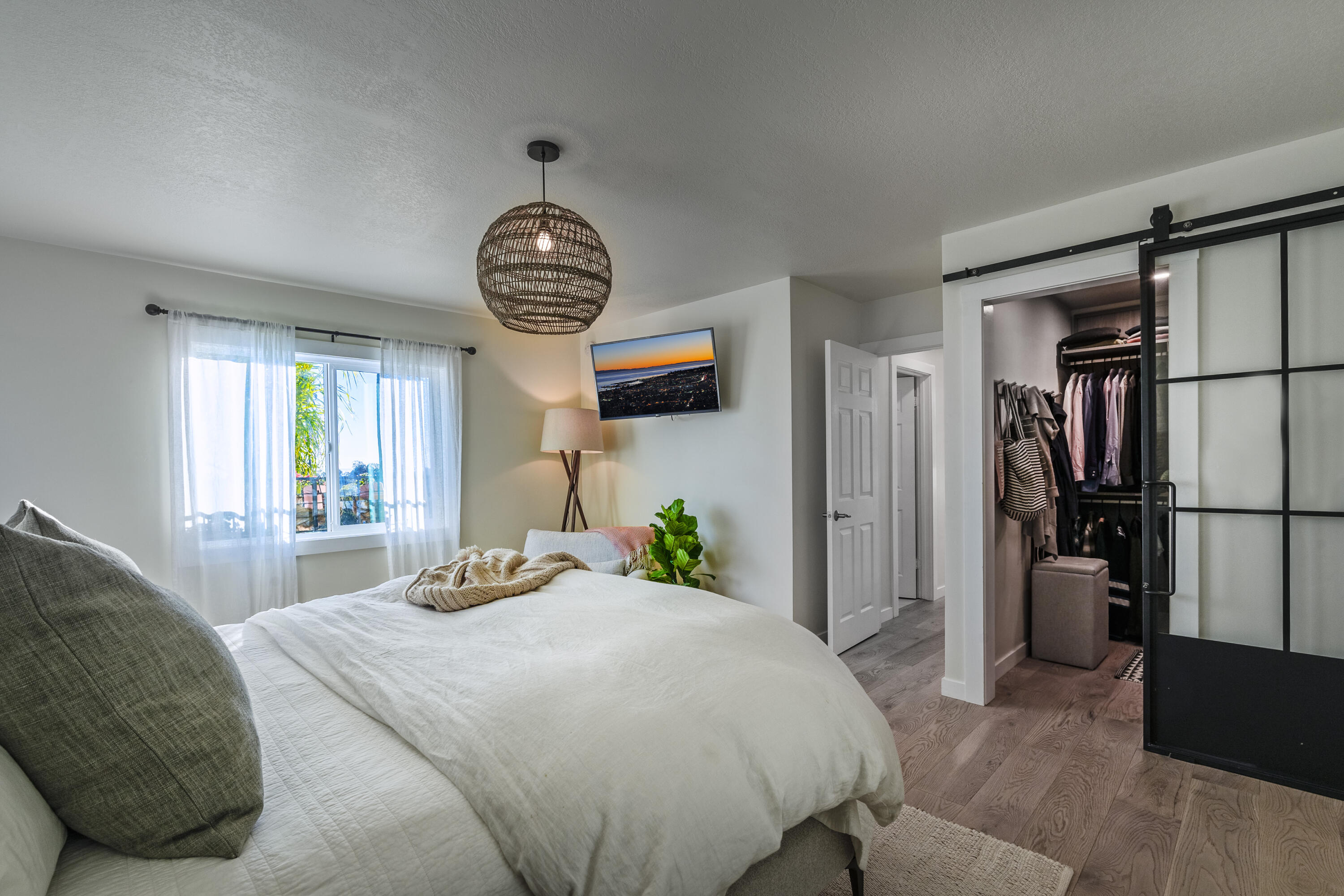 435 Fellowship Road Santa Barbara, CA 93109 - Photo 16 of 38 a bedroom with a bed and a chandelier