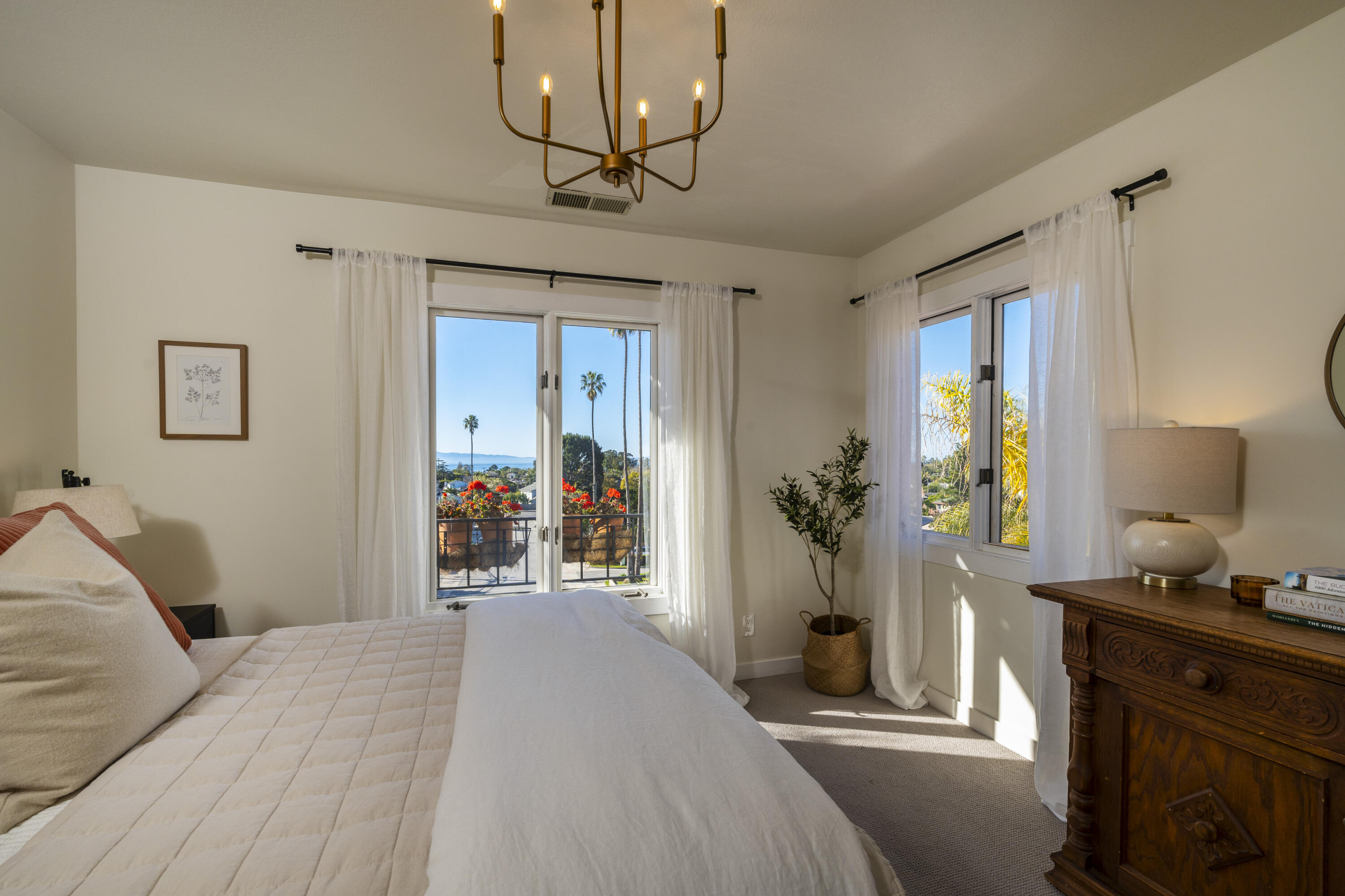 435 Fellowship Road Santa Barbara, CA 93109 - Photo 20 of 38 a bedroom with a bed and a chandelier