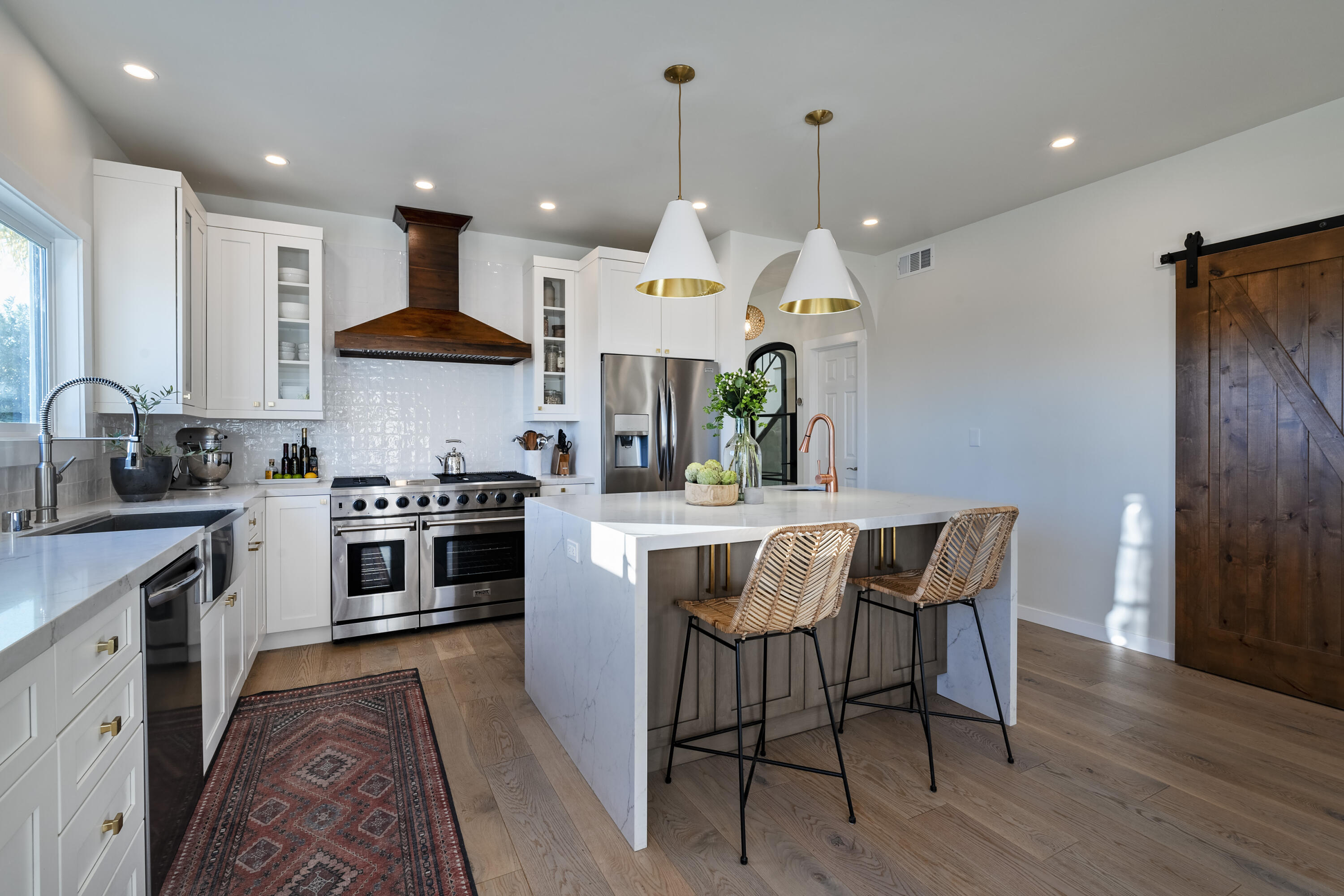 435 Fellowship Road Santa Barbara, CA 93109 - Photo 8 of 38 a kitchen with stainless steel appliances a dining table chairs stove and sink