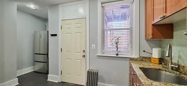 a kitchen with a refrigerator and a sink