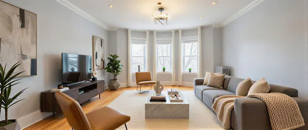 a living room with furniture a large window and a flat screen tv