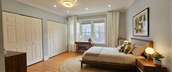 a bedroom with a bed and wooden floor