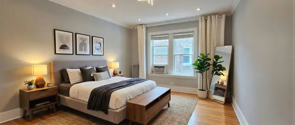 a spacious bedroom with a bed and a potted plant