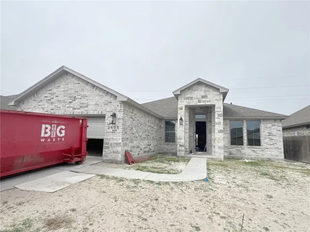 a view of a brick house with large windows