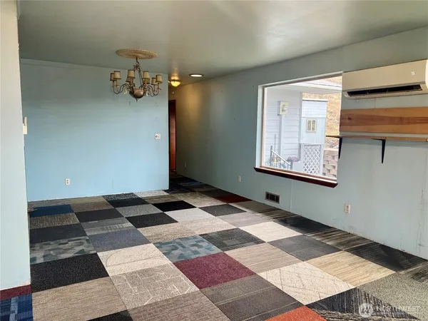 a view of a room with window and stairs