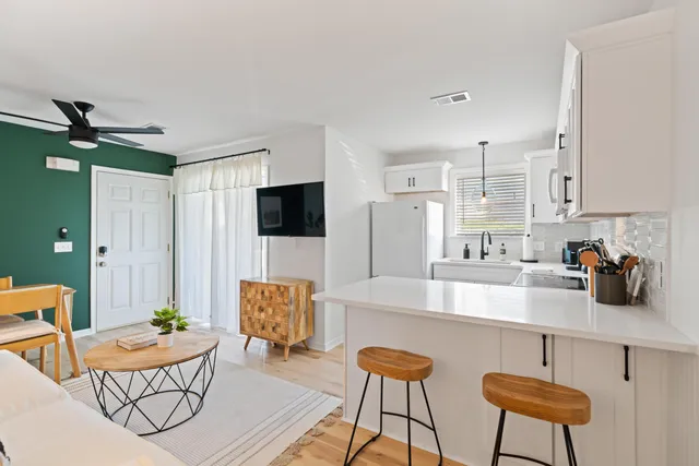 a kitchen with a dining table and chairs