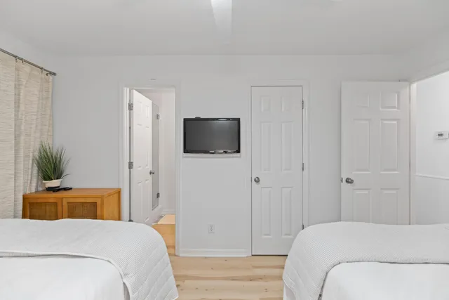 a bedroom with a bed and a flat screen tv