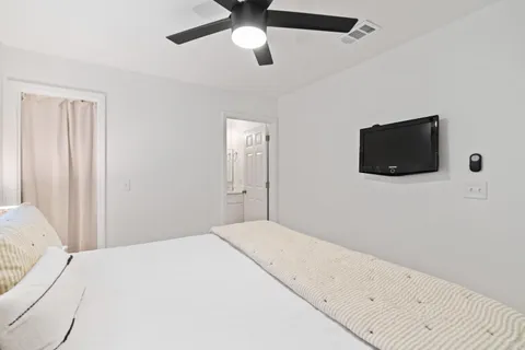 a bedroom with a bed and a flat screen tv