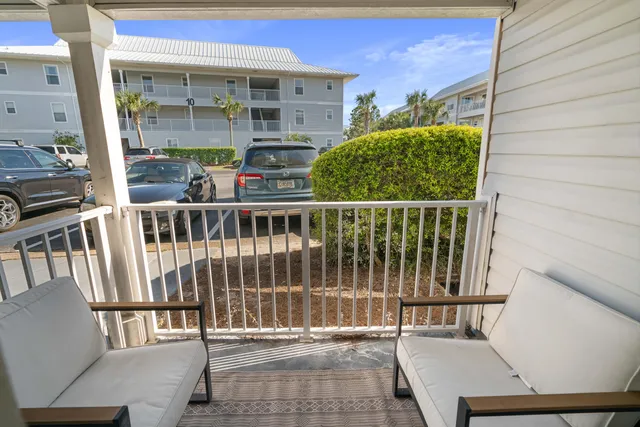 a balcony with table and chairs