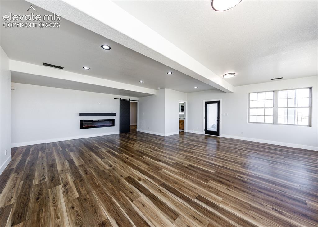 1120 Newton Road Pueblo, CO 81005 - Photo 24 of 46 an empty room with wooden floor and a window