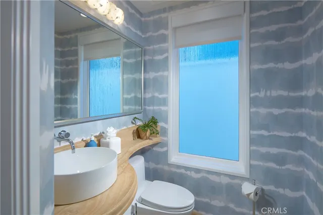 a bathroom with a granite countertop sink a mirror and a bathtub