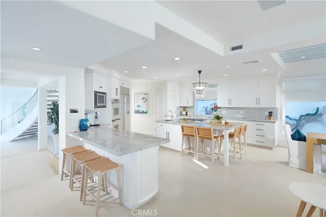 a kitchen with stainless steel appliances kitchen island granite countertop a sink and cabinets