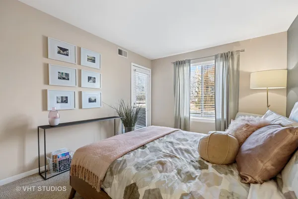 a bedroom with a bed and a chair