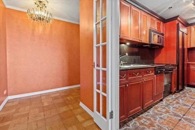 a view of empty room with wooden floor and cabinet
