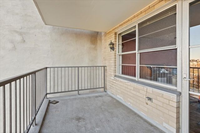 a view of empty room with wooden floor and sink