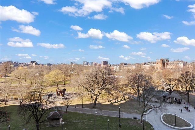 a view of a city with lush green forest