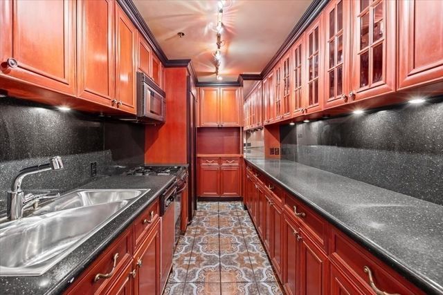 a kitchen with stainless steel appliances granite countertop a stove and a sink