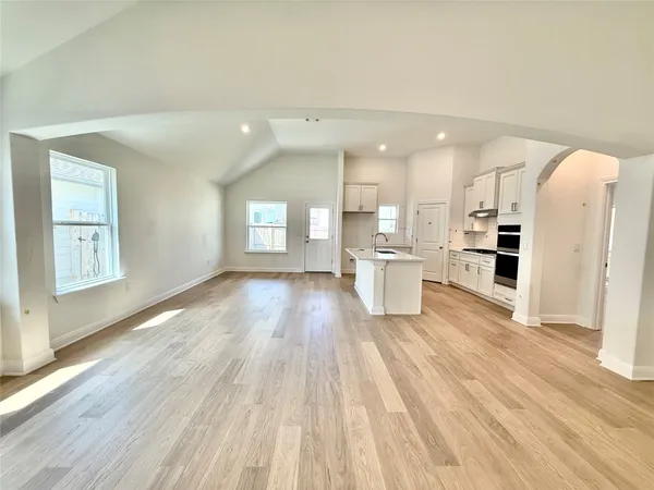 a view of kitchen with wooden floor and electronic appliances
