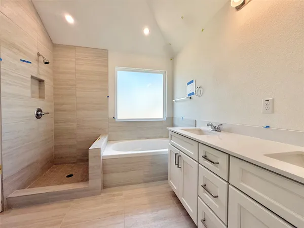 a bathroom with a shower sink and mirror