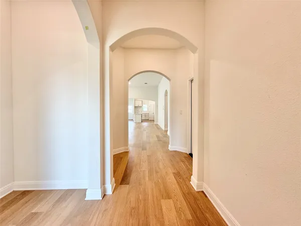 a view of a hallway with wooden floor
