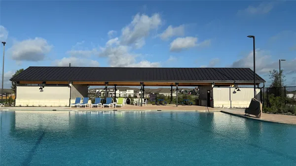 a view of a swimming pool and an outdoor seating