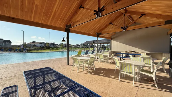 a view of a patio with swimming pool table and chairs