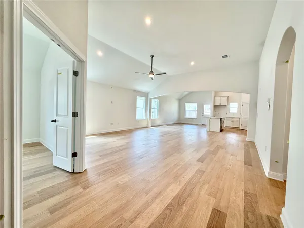 a view of empty room with wooden floor