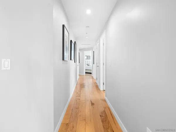 a view of a hallway with wooden floor and entryway