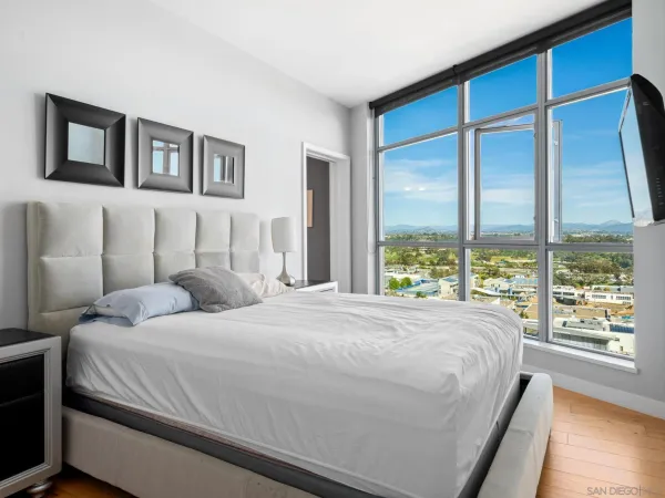 a bedroom with a large bed and a large window