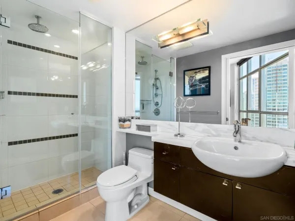 a bathroom with a sink toilet a mirror and shower