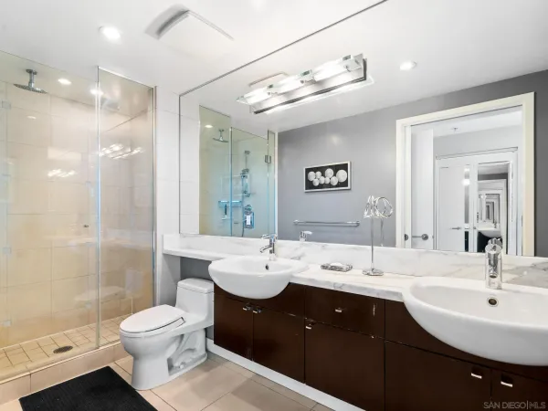a spacious bathroom with a bathtub shower sink mirror vanity and toilet