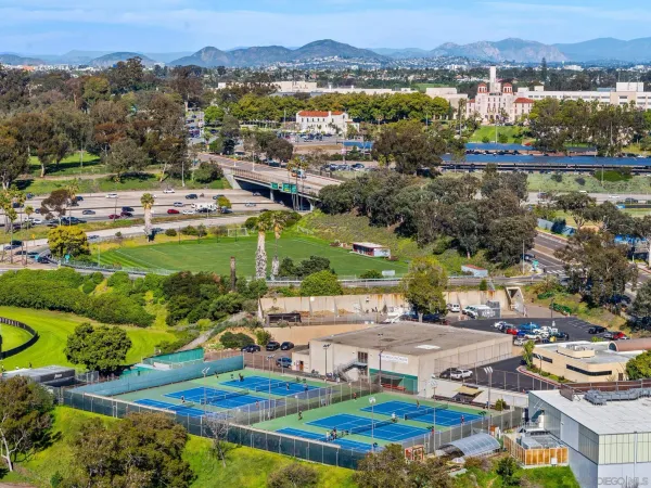 an aerial view of residential houses with outdoor space and lake view