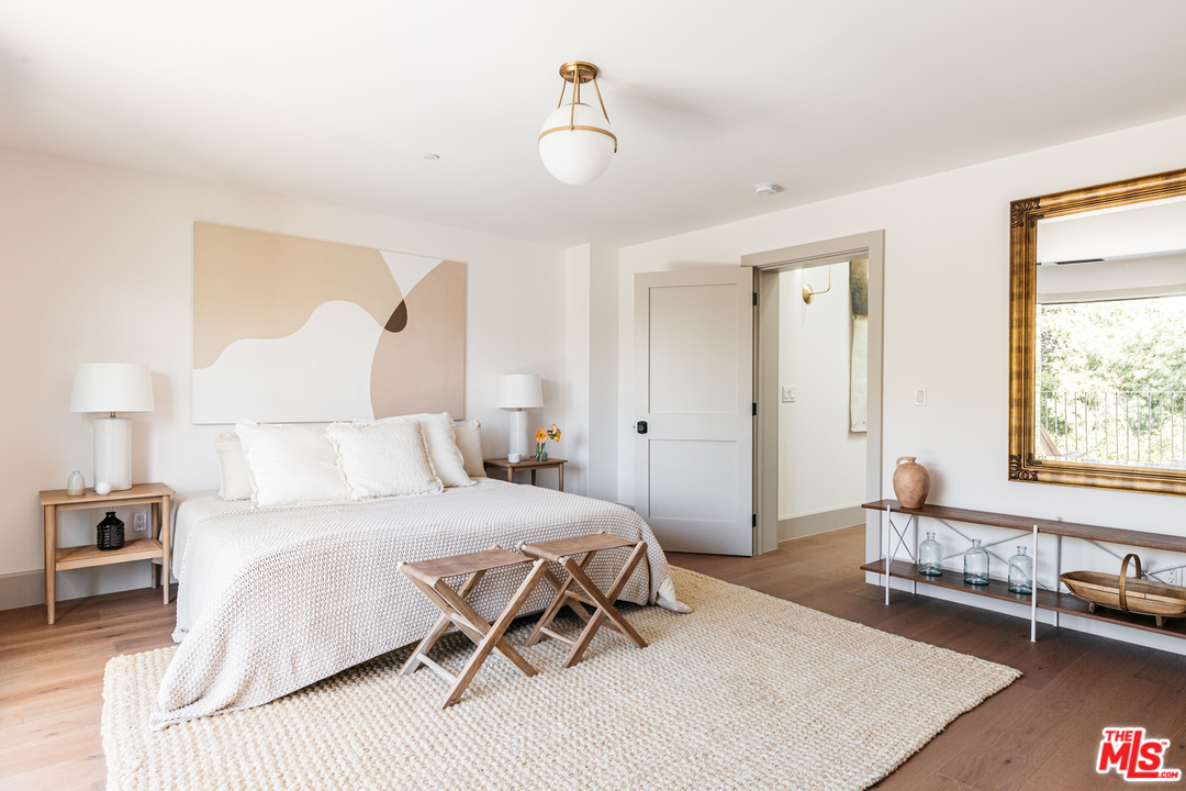 1321 North Benton Way Los Angeles, CA 90026 - Photo 11 of 27 a bedroom with a bed and a table