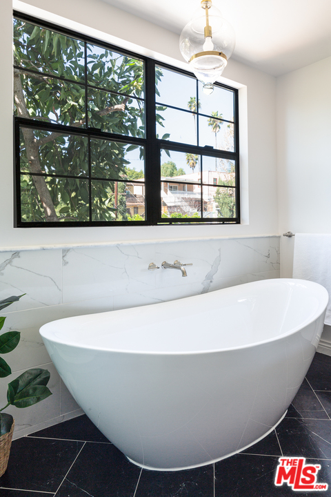 1321 North Benton Way Los Angeles, CA 90026 - Photo 14 of 27 a white tub sitting in front of a window
