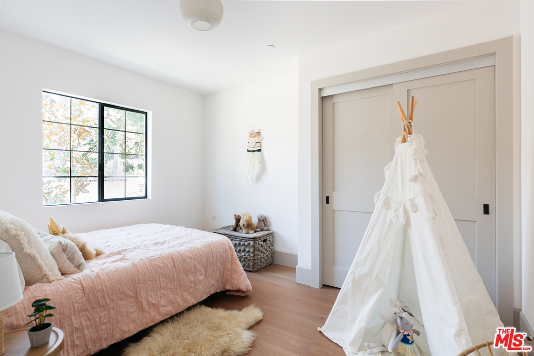1321 North Benton Way Los Angeles, CA 90026 - Photo 15 of 27 a bedroom with a bed and a window