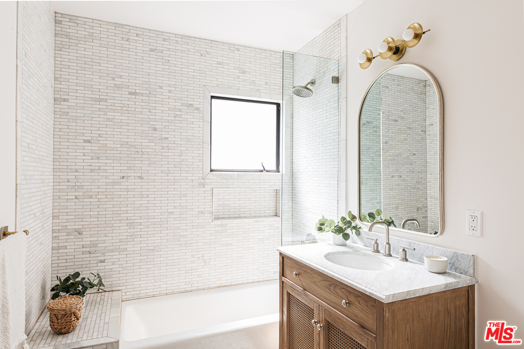 1321 North Benton Way Los Angeles, CA 90026 - Photo 16 of 27 a bathroom with a sink and a mirror