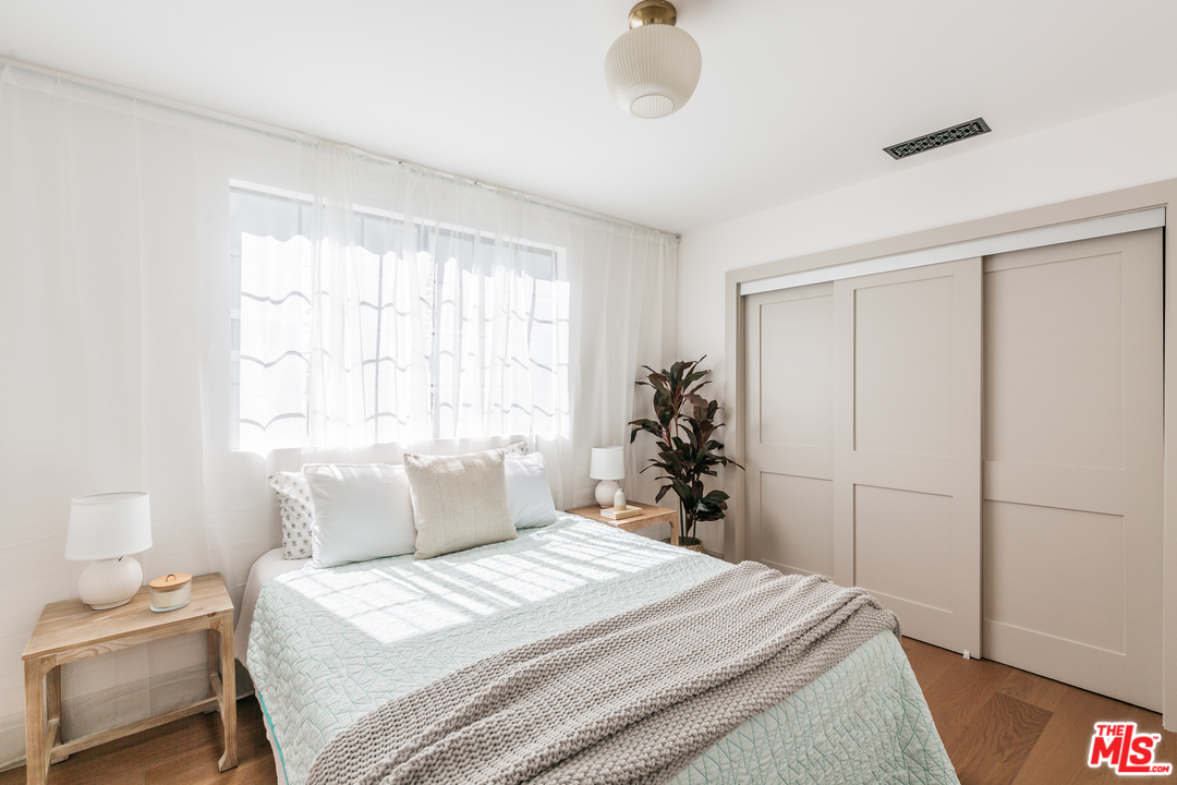 1321 North Benton Way Los Angeles, CA 90026 - Photo 17 of 27 a bedroom with a bed and a window