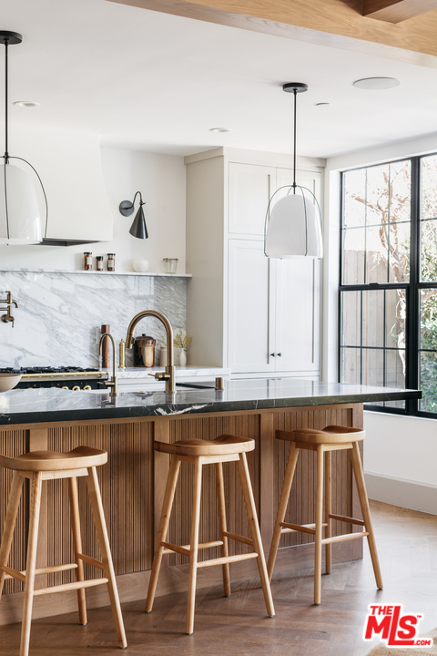 1321 North Benton Way Los Angeles, CA 90026 - Photo 8 of 27 a kitchen with granite countertop a table chairs stove and sink