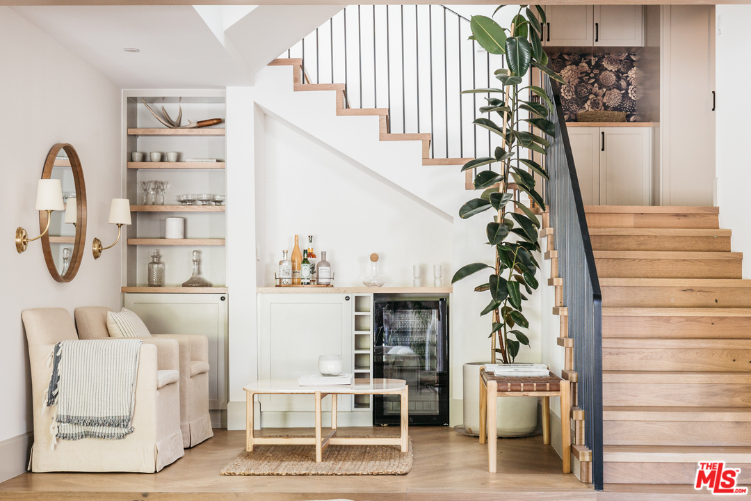 1321 North Benton Way Los Angeles, CA 90026 - Photo 9 of 27 a living room with furniture a rug and white walls with a white comforter