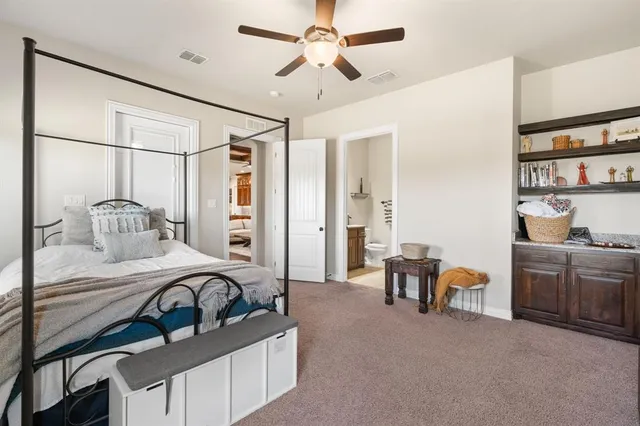 a kitchen with stainless steel appliances kitchen island granite countertop a table chairs and a refrigerator