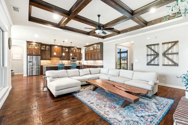 a living room with furniture wooden floor and a table