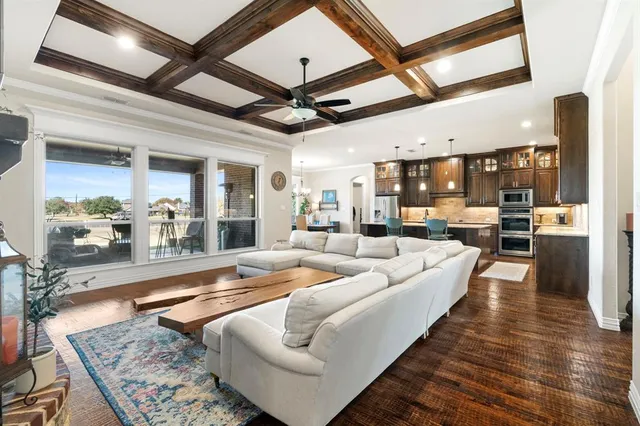a view of a livingroom with furniture fireplace and wooden floor