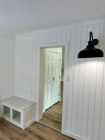 a view of a livingroom with wooden floor and a sink