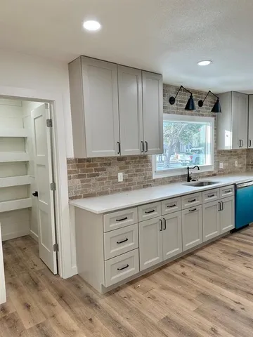 a kitchen with a sink stove and cabinets
