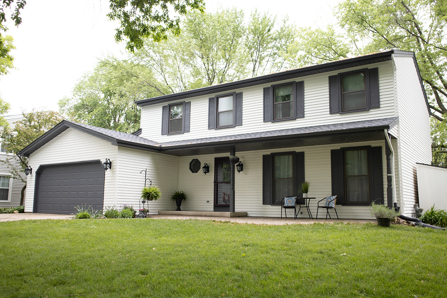 a view of a house with a yard patio and fire pit