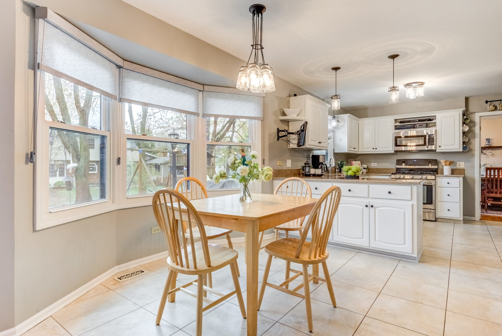 1220 Arthur Road Naperville, IL 60540 - Photo 9 of 24 a kitchen with kitchen island a large counter top space appliances and a center island