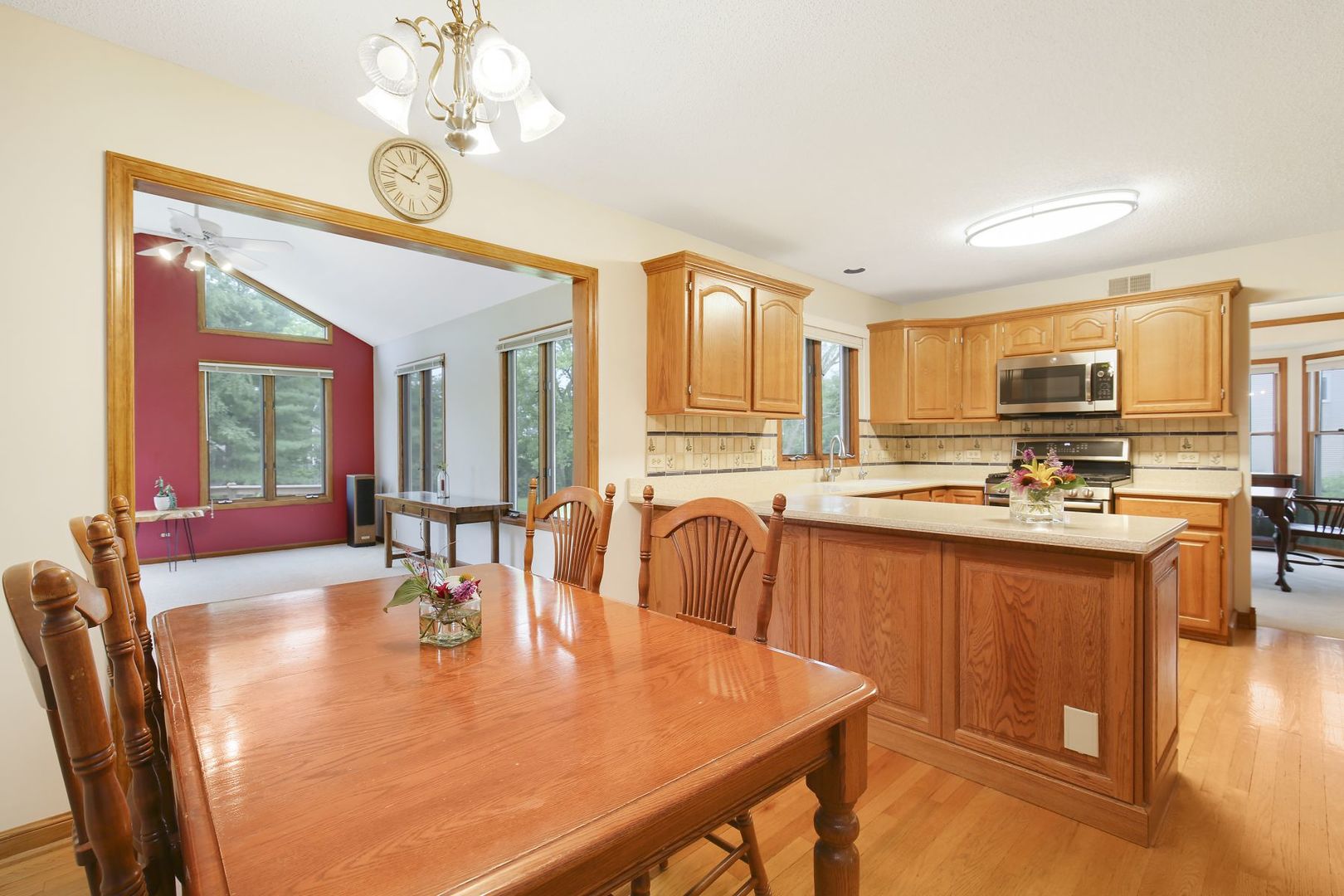 152 Wilcox Drive Bartlett, IL 60103 - Photo 13 of 51 a large kitchen with kitchen island granite countertop a stove a sink a dining table and chairs with wooden floor