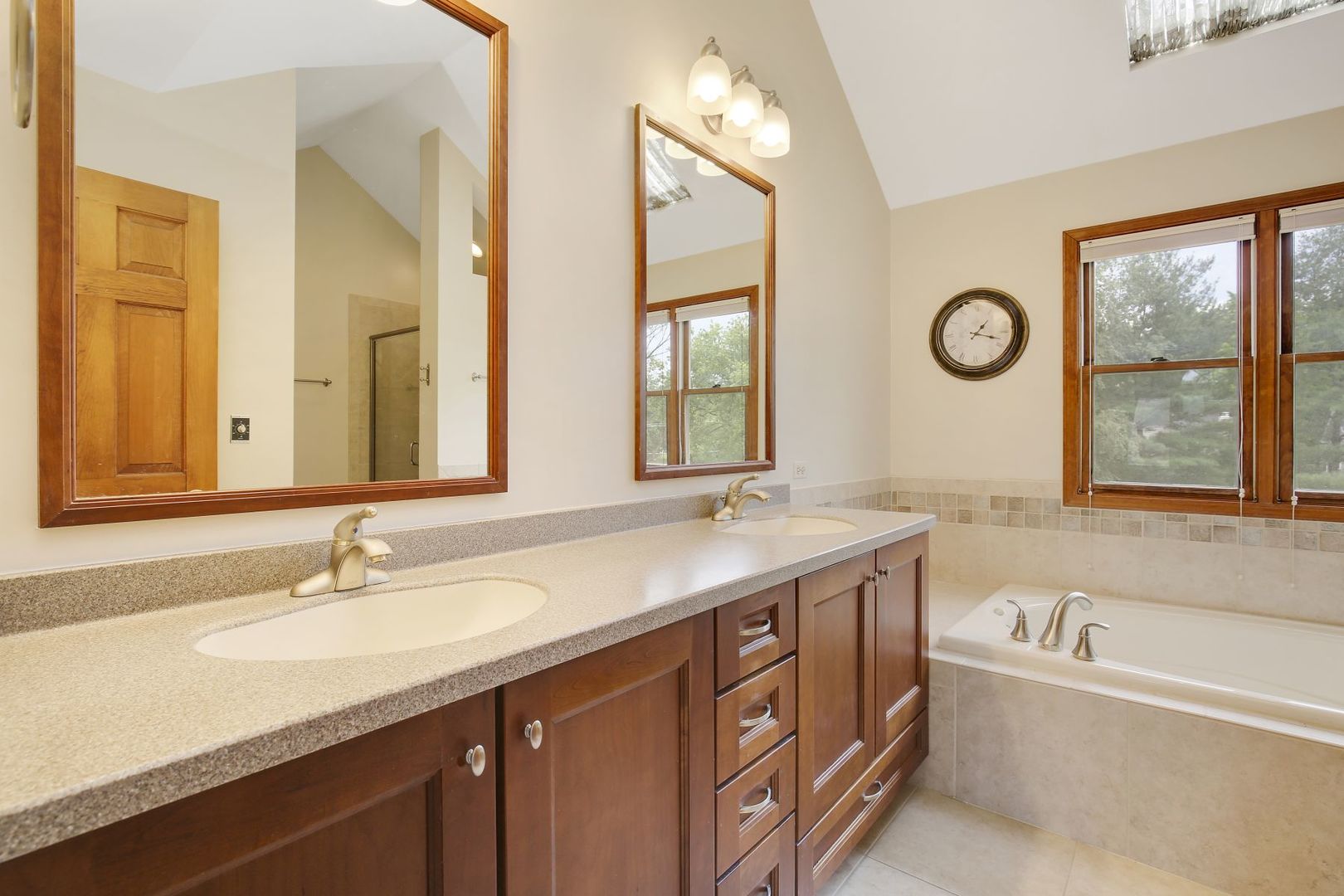 152 Wilcox Drive Bartlett, IL 60103 - Photo 26 of 51 a bathroom with a granite countertop sink and a large mirror