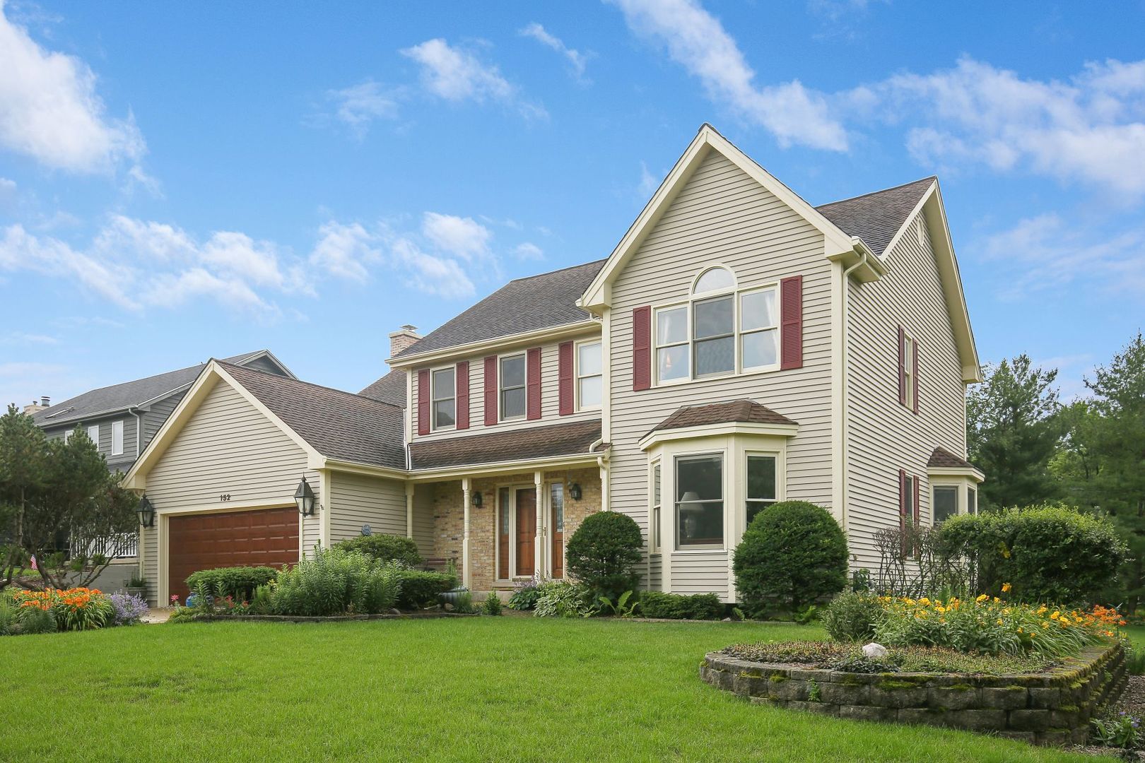 152 Wilcox Drive Bartlett, IL 60103 - Photo 4 of 51 a front view of a house with a yard and trees
